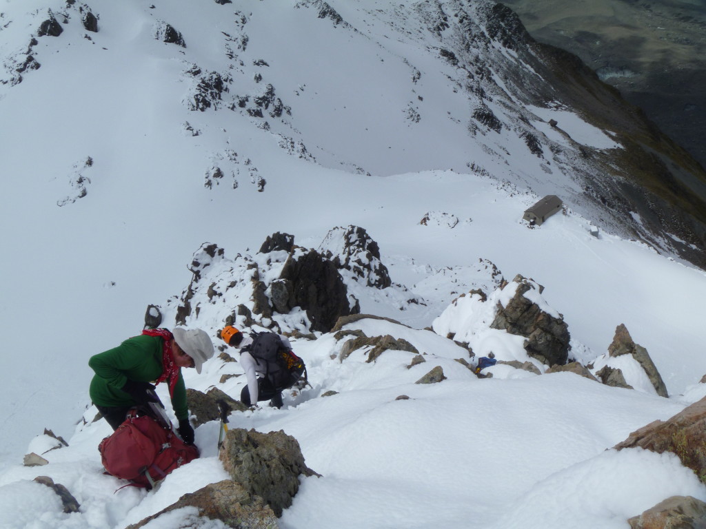 Keeping as high as we can to stay out of the firing line of point-release avalanches, descending a ridge near Caroline Hut